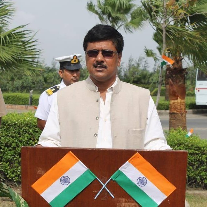 Portrait of Dr. Binod Kumar Singh at a podium with the Indian tricolour
