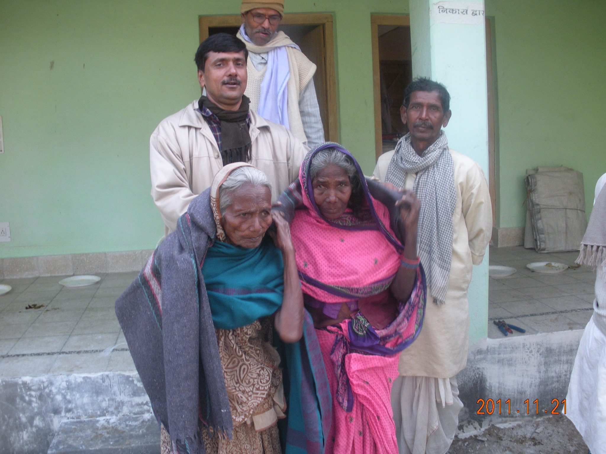Dr. Singh supporting two elderly women at a trust outreach, November 2011